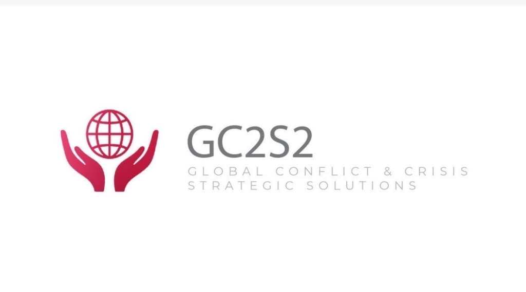 red hands at the bottom of a globe with the text GC2S2 and Global Conflict & Crisis Strategic Solutions written out